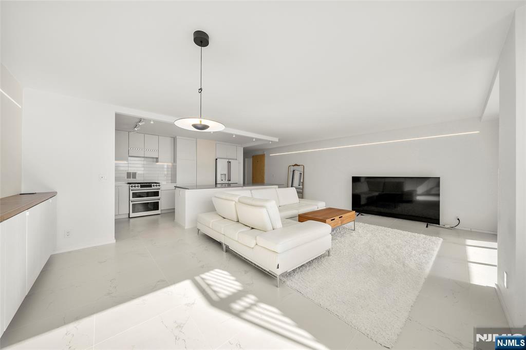 200 Old Palisade Road, Unit 25D Fort Lee, NJ 07024 - Photo 10 of 30 a living room with furniture and a flat screen tv