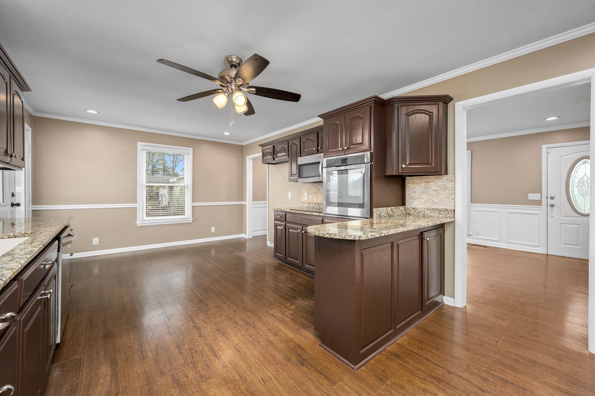 6580 Burkitt Road Antioch, TN 37013 - Photo 14 of 62 a kitchen with kitchen island granite countertop a sink cabinets and wooden floor