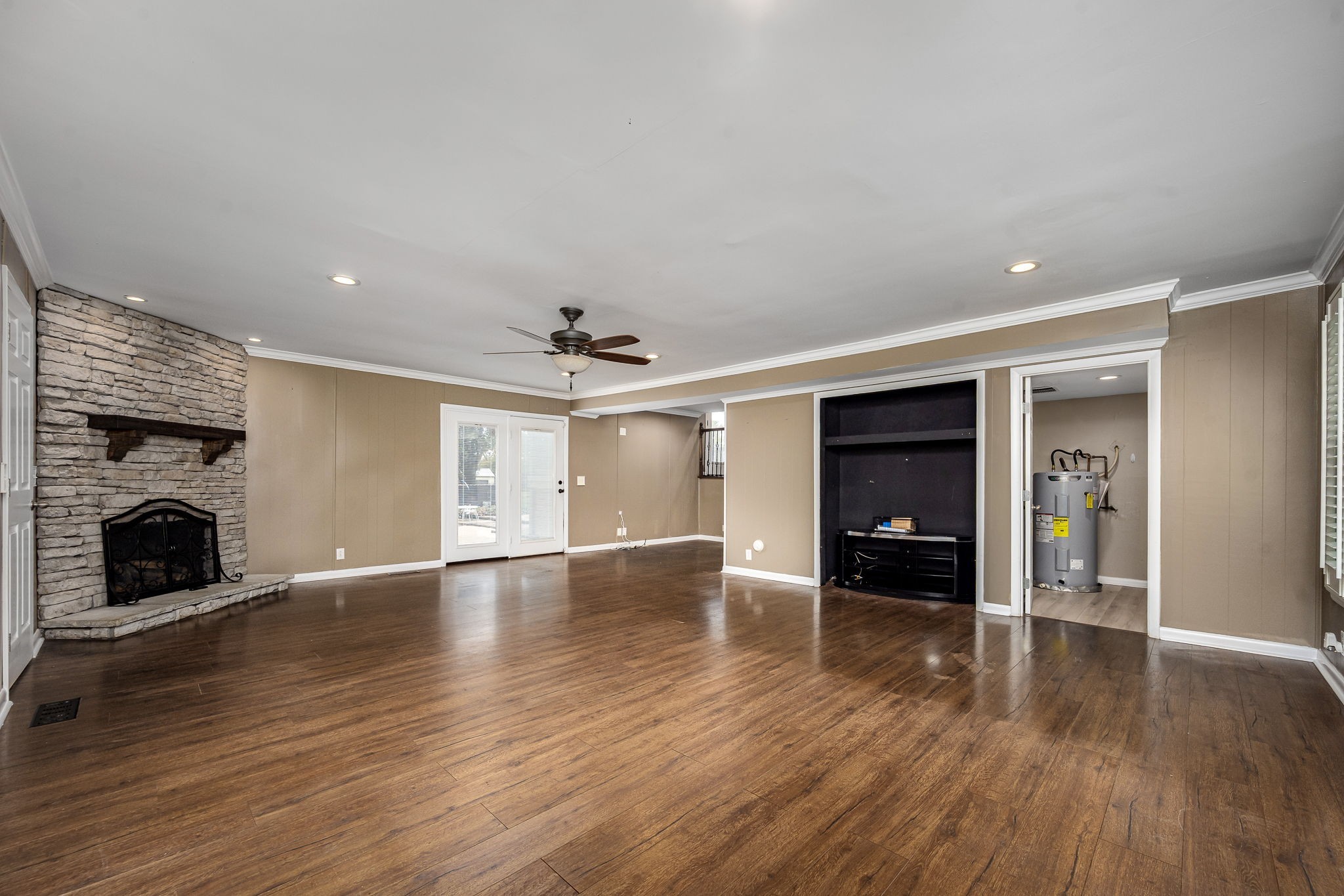 6580 Burkitt Road Antioch, TN 37013 - Photo 28 of 62 an empty room with wooden floor fireplace and cabinet