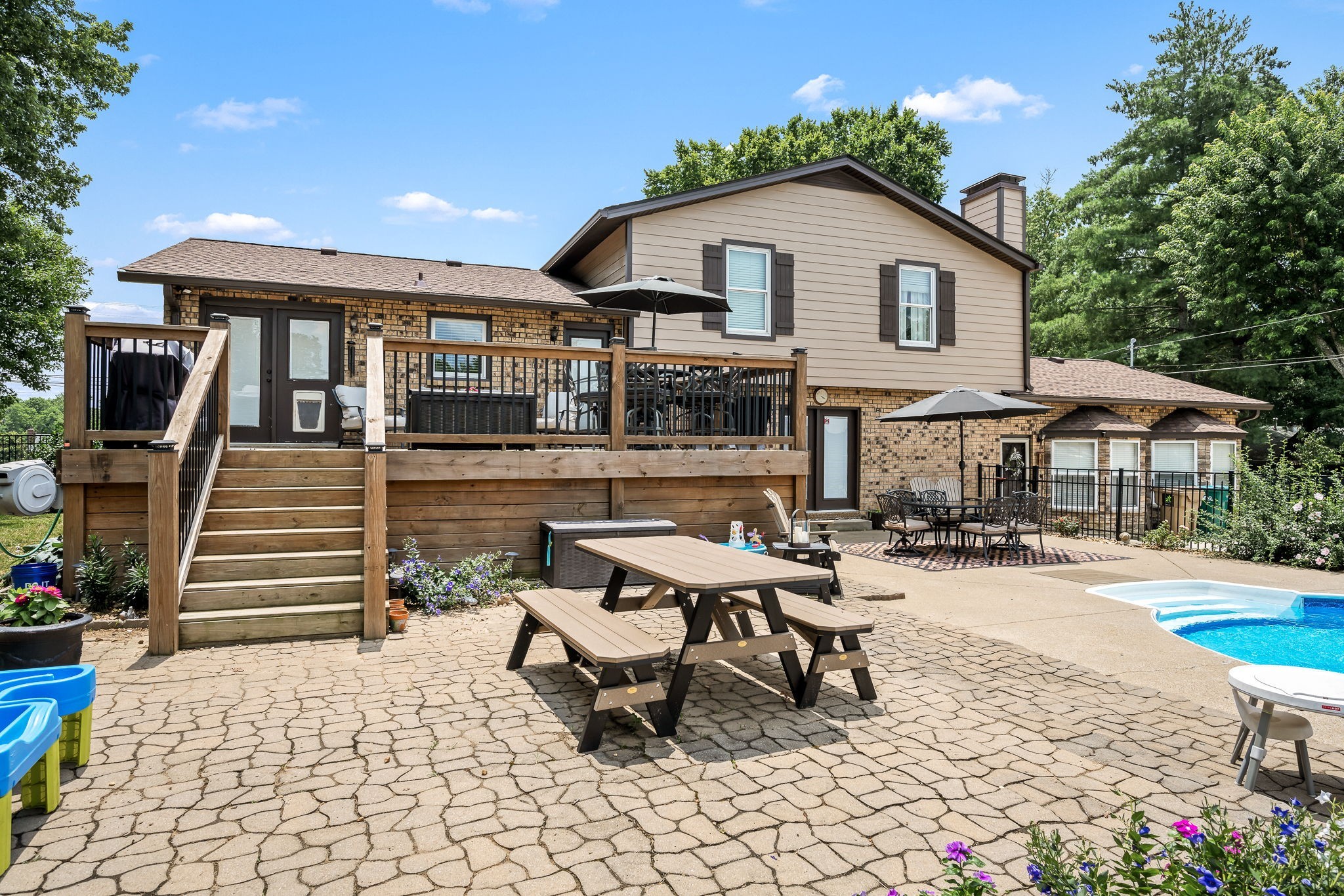 6580 Burkitt Road Antioch, TN 37013 - Photo 35 of 62 a roof deck with a table and chairs under an umbrella