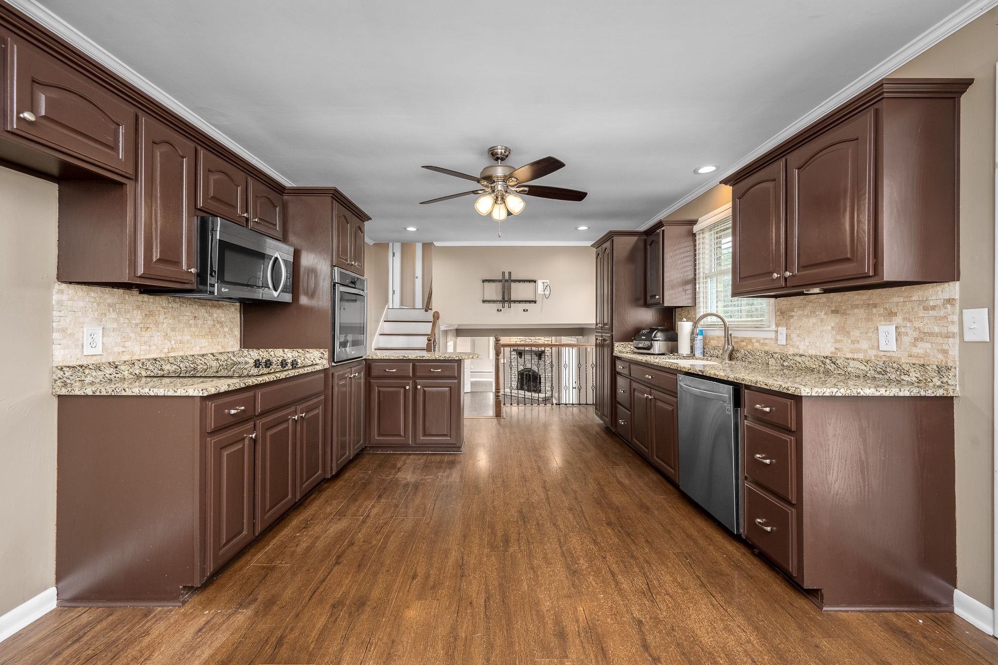 6580 Burkitt Road Antioch, TN 37013 - Photo 9 of 62 a kitchen with stainless steel appliances granite countertop wooden cabinets a sink a stove a refrigerator and island with wooden floors