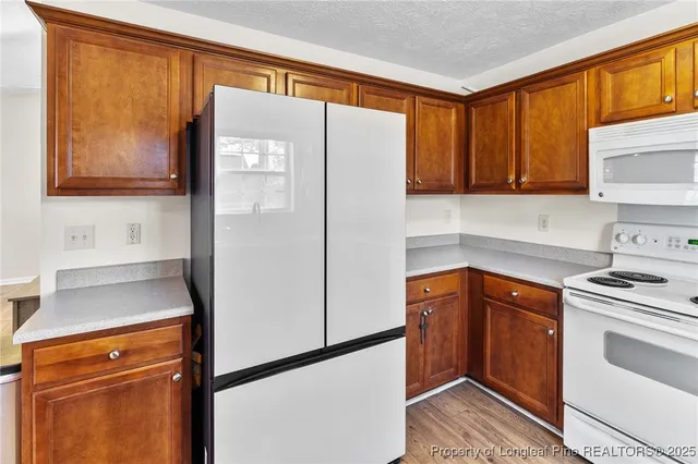 a kitchen with stainless steel appliances a refrigerator sink and cabinets