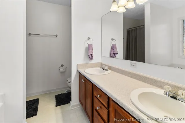 a bathroom with a double vanity sink and a mirror