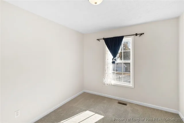 an empty room with windows and entryway