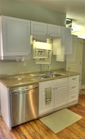 a kitchen with stainless steel appliances granite countertop a sink and a stove