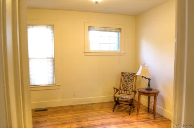 a room with a window and chairs