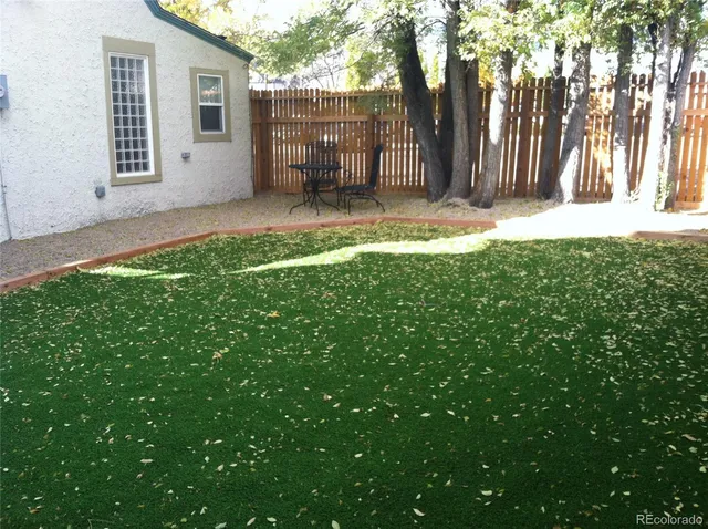 a view of a backyard with a tree