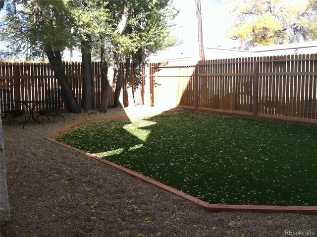 a view of a backyard with large trees