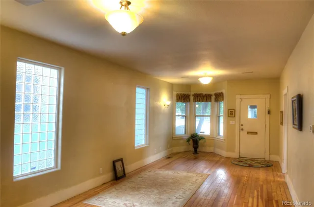 a view of a livingroom with wooden floor and a window