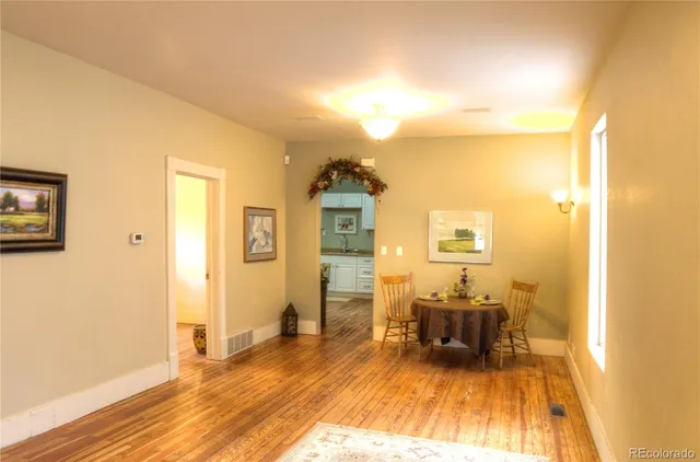 a room with wooden floor and furniture