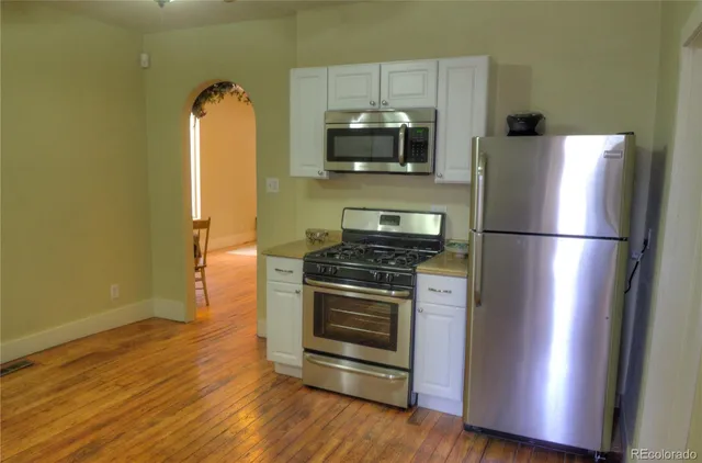 a kitchen with a refrigerator and a microwave