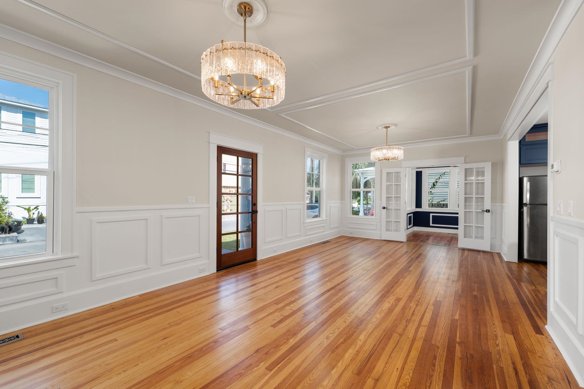 142 Washington Street St. Augustine, FL 32084 - Photo 18 of 53 a view of an empty room with wooden floor and a window