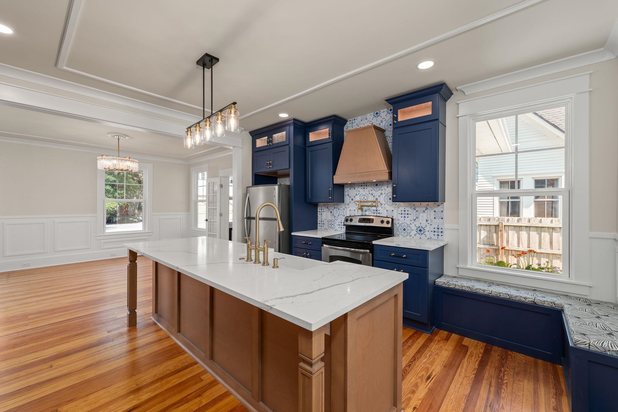 142 Washington Street St. Augustine, FL 32084 - Photo 21 of 53 a kitchen with a sink appliances wooden floor and a window