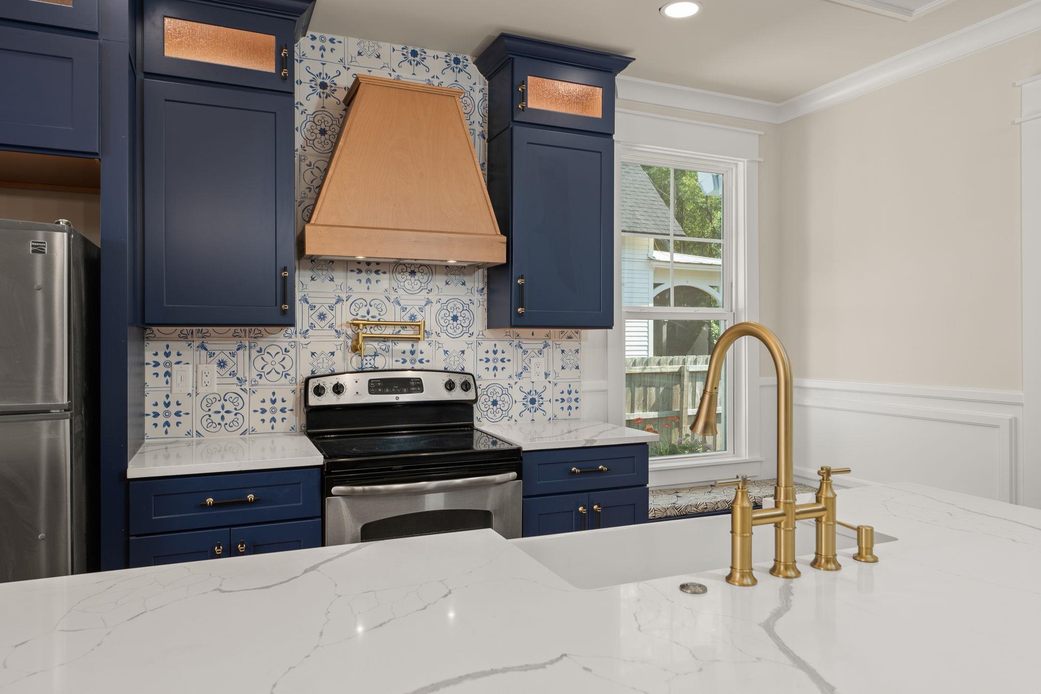 142 Washington Street St. Augustine, FL 32084 - Photo 22 of 53 a kitchen with stainless steel appliances a stove refrigerator and cabinets
