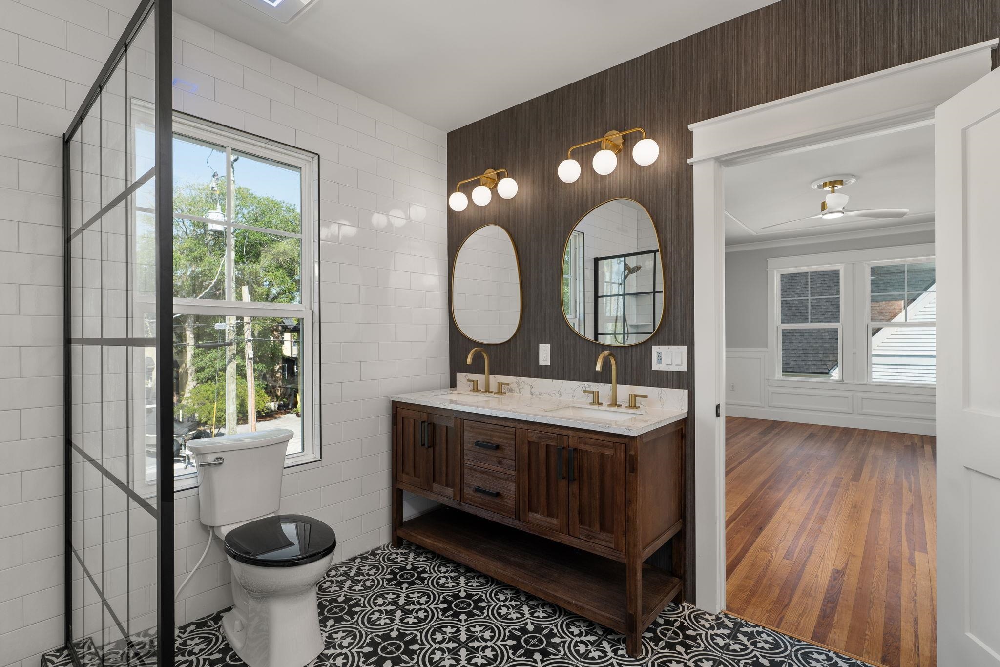 142 Washington Street St. Augustine, FL 32084 - Photo 39 of 53 a bathroom with a toilet sink and mirror