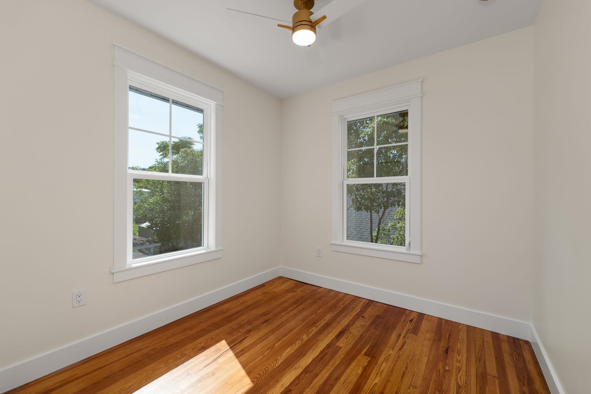 142 Washington Street St. Augustine, FL 32084 - Photo 42 of 53 an empty room with wooden floor and windows