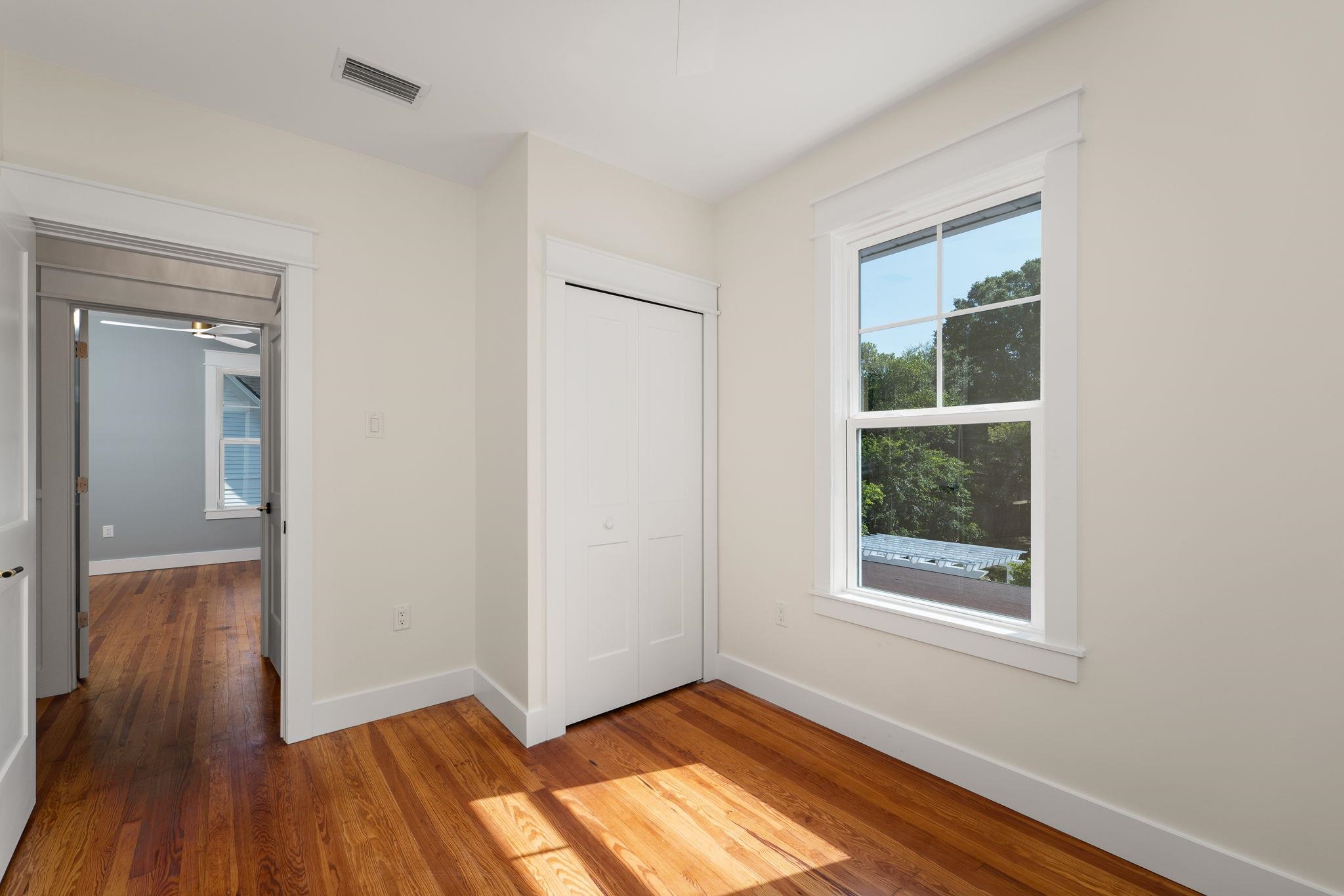 142 Washington Street St. Augustine, FL 32084 - Photo 43 of 53 an empty room with wooden floor and windows