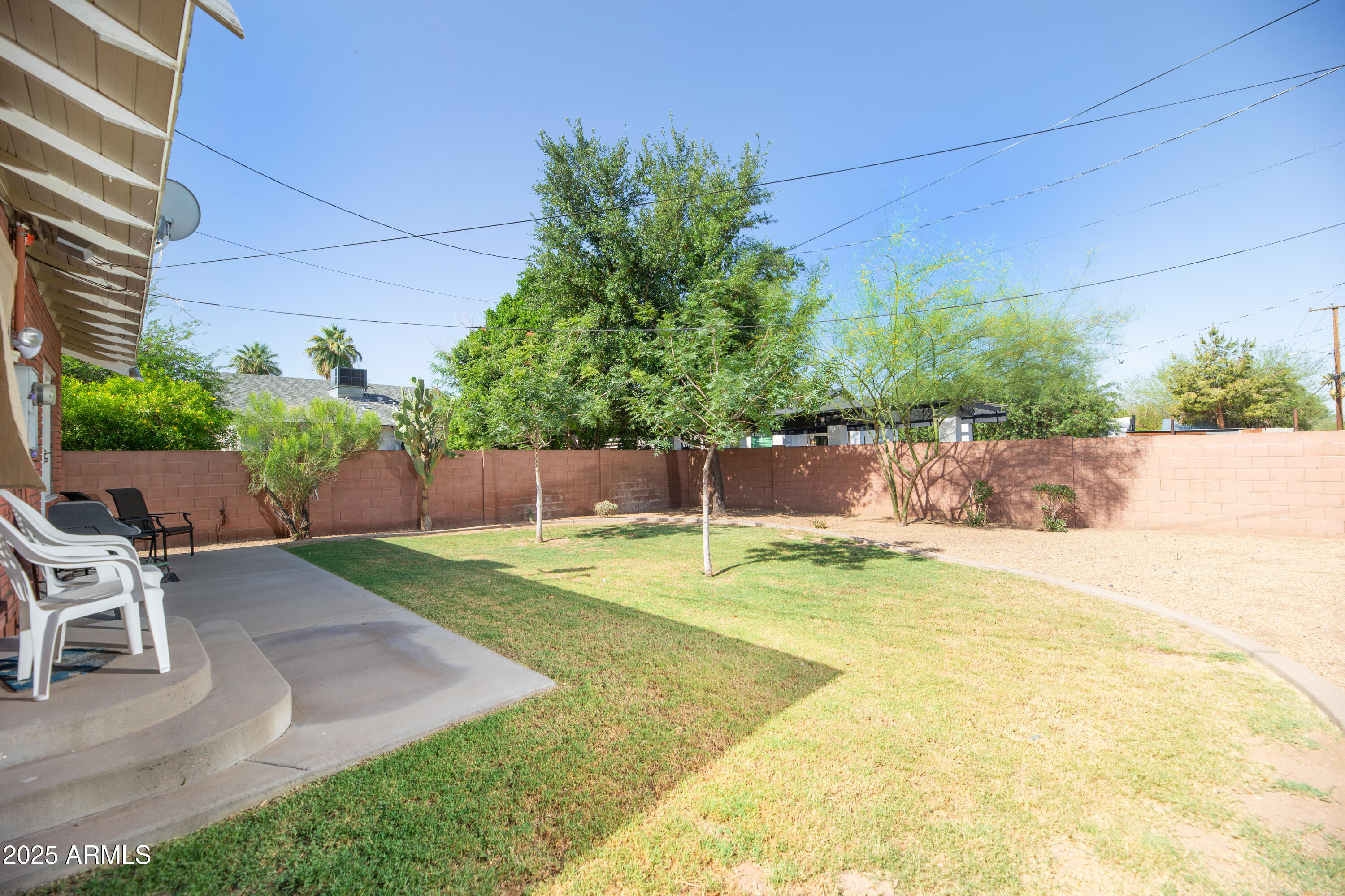 1650 North 10th Street Phoenix, AZ 85006 - Photo 22 of 29 a view of a backyard with table and chairs potted plants and wooden fence