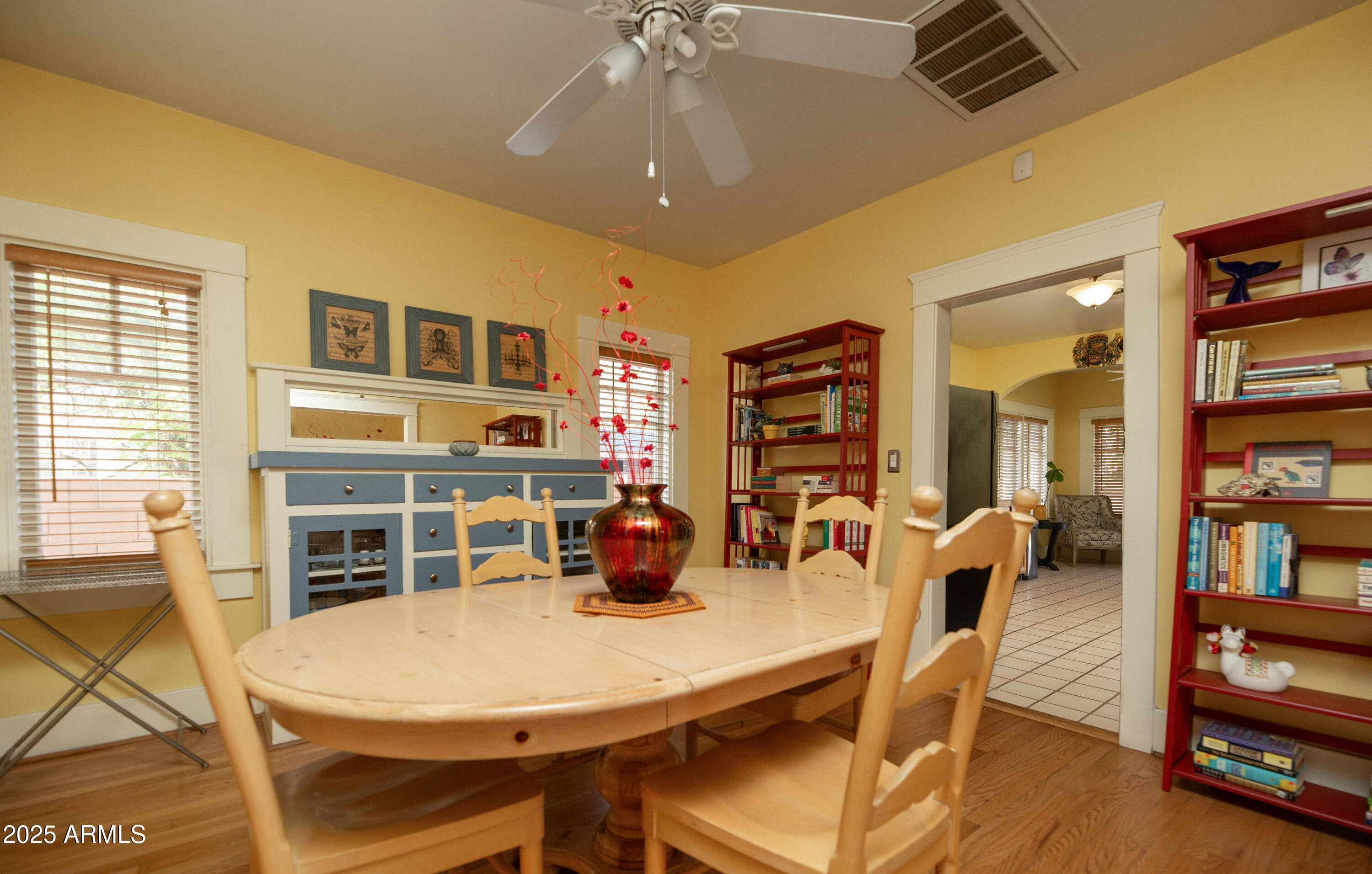 1650 North 10th Street Phoenix, AZ 85006 - Photo 9 of 29 a living room with furniture a dining table and a bookshelf