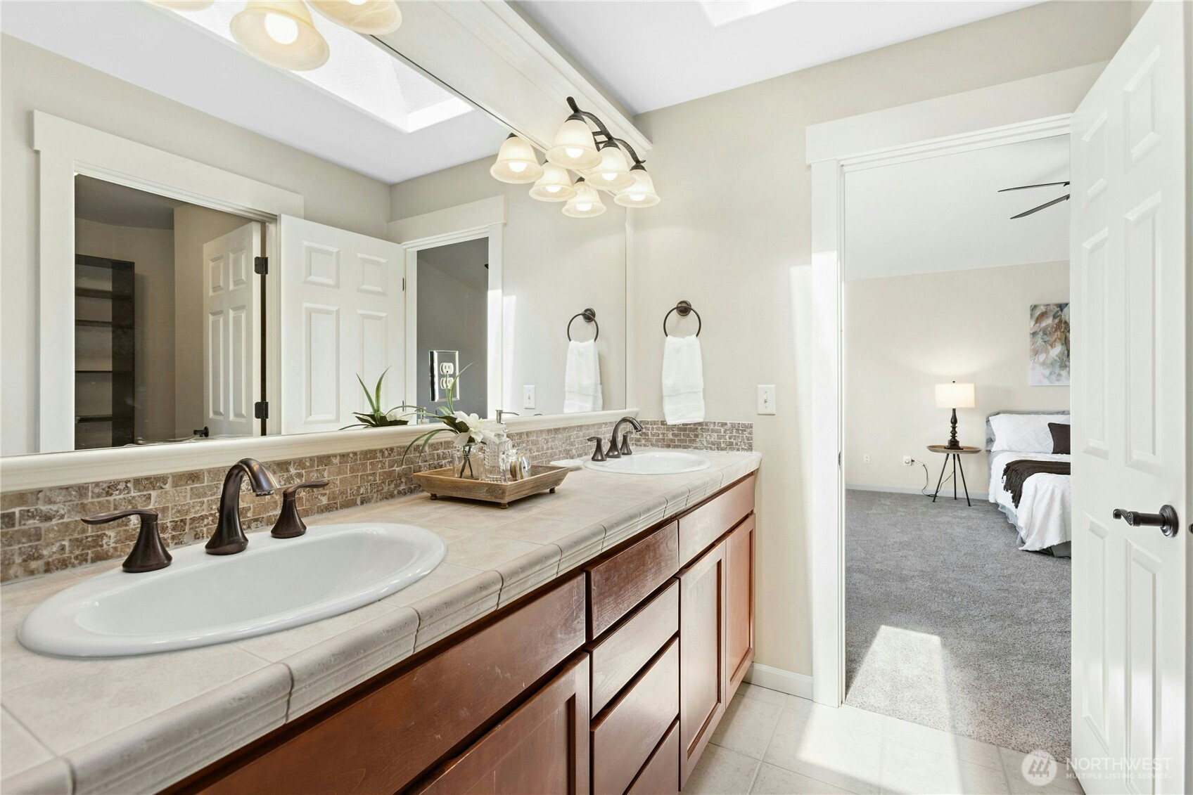 22624 43rd Drive Southeast Bothell, WA 98021 - Photo 20 of 36 a en suite bathroom with a double vanity sink and a mirror