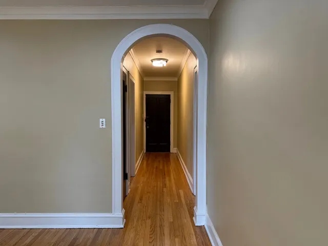 a view of a hallway with wooden floor