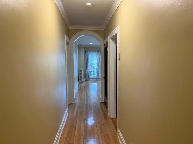 a view of a hallway with wooden floor