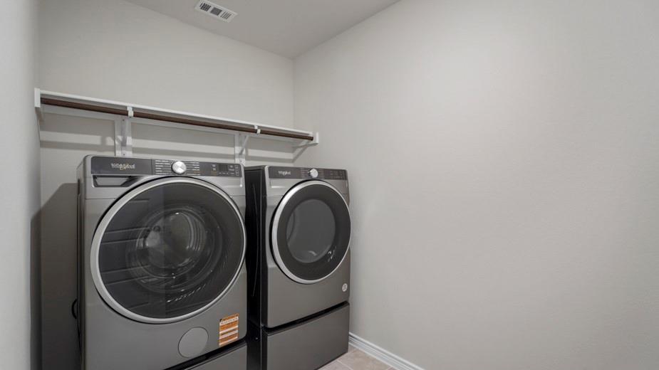 439 Epiphany Lane Lavon, TX 75166 - Photo 12 of 31 Dedicated laundry space with light gray walls, white baseboards, and a built-in hanging rod