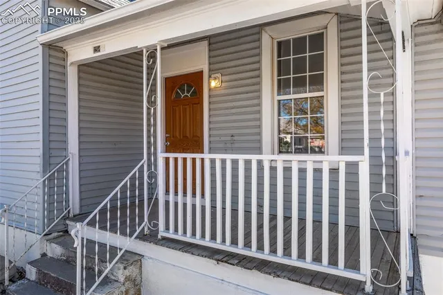 a view of a brick house with wooden fence