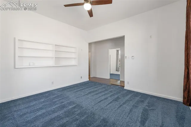 an empty room with wooden floor cabinet and closet