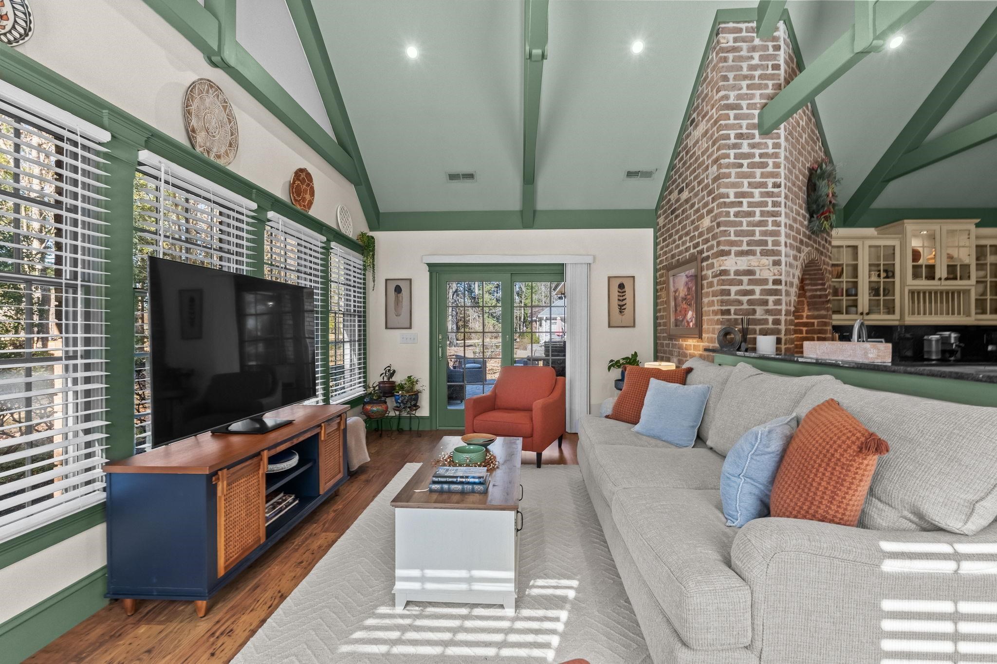 400 Foxtail Drive Longs, SC 29568 - Photo 14 of 40 Living room featuring high vaulted ceiling, wood finished floors, beam ceiling, and brick wall
