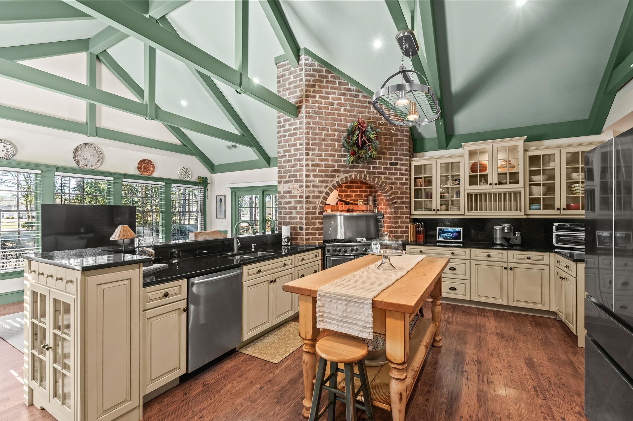 400 Foxtail Drive Longs, SC 29568 - Photo 17 of 40 Kitchen featuring glass insert cabinets, cream cabinetry, high vaulted ceiling, dark stone counters, and dark wood-style floors
