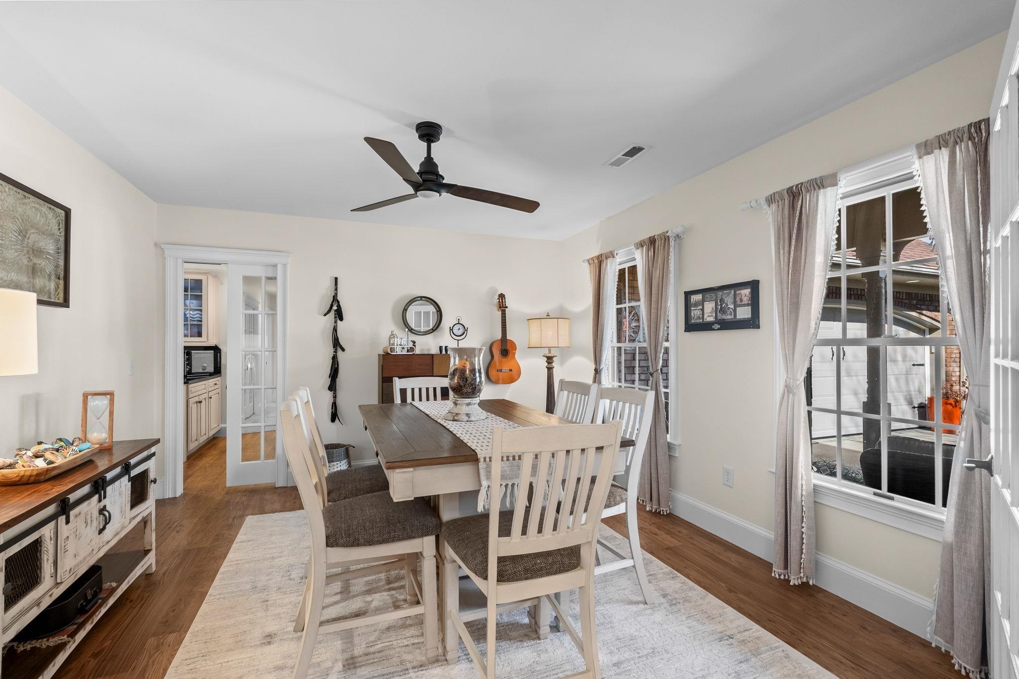400 Foxtail Drive Longs, SC 29568 - Photo 6 of 40 Dining space with dark wood-style flooring, ceiling fan, and french doors