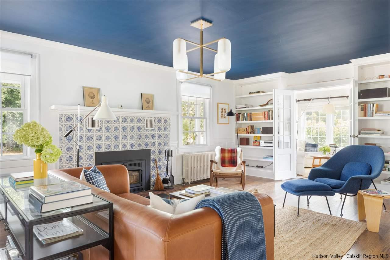 1162 Plains Road Wallkill, NY 12589 - Photo 13 of 35 a living room with furniture a fireplace and a floor to ceiling window