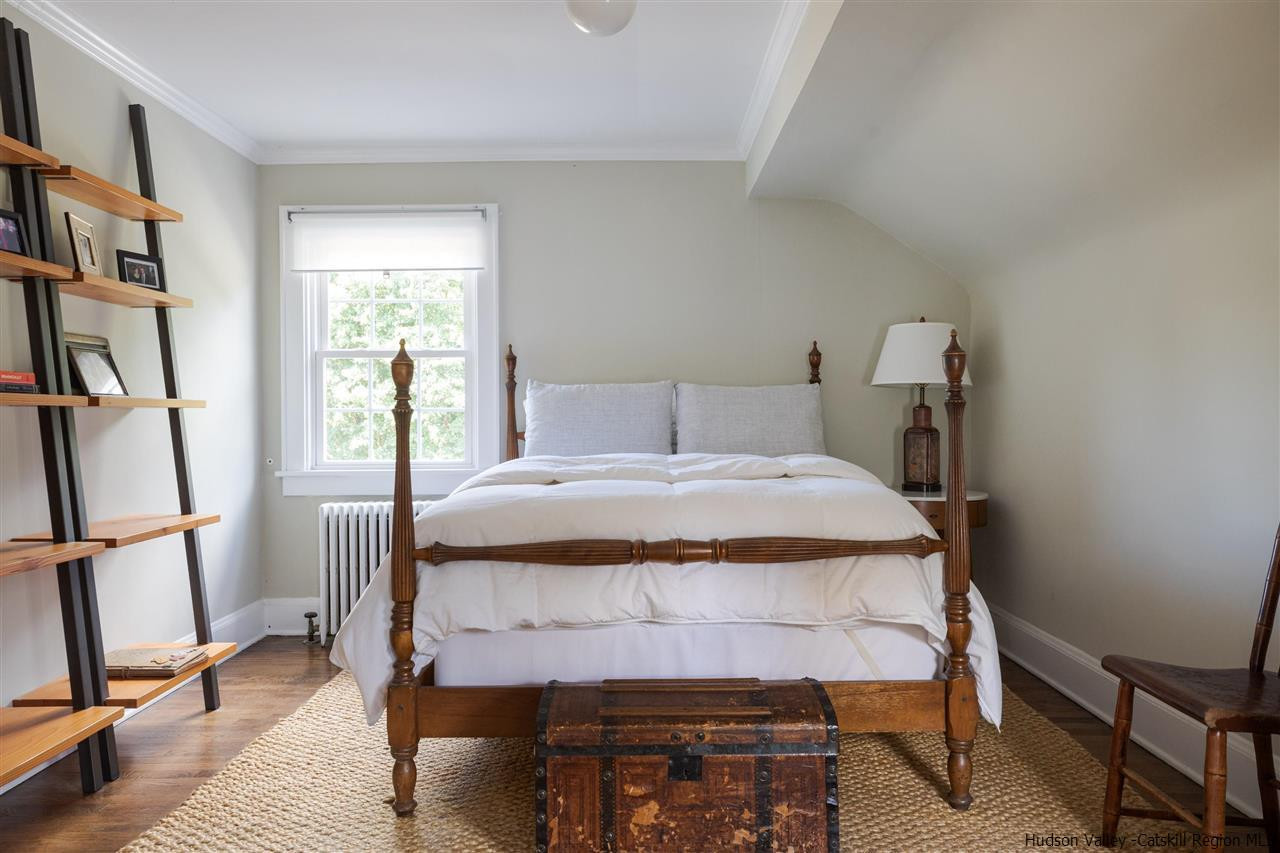 1162 Plains Road Wallkill, NY 12589 - Photo 23 of 35 a bedroom with a bed a dresser and a book shelf