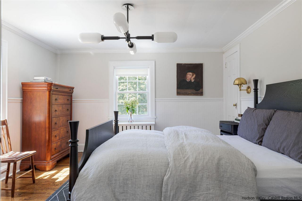 1162 Plains Road Wallkill, NY 12589 - Photo 28 of 35 a bedroom with a bed and a flat tv screen