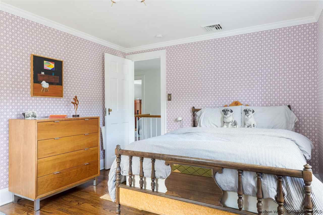 1162 Plains Road Wallkill, NY 12589 - Photo 8 of 35 a bedroom with a bed and wooden floor