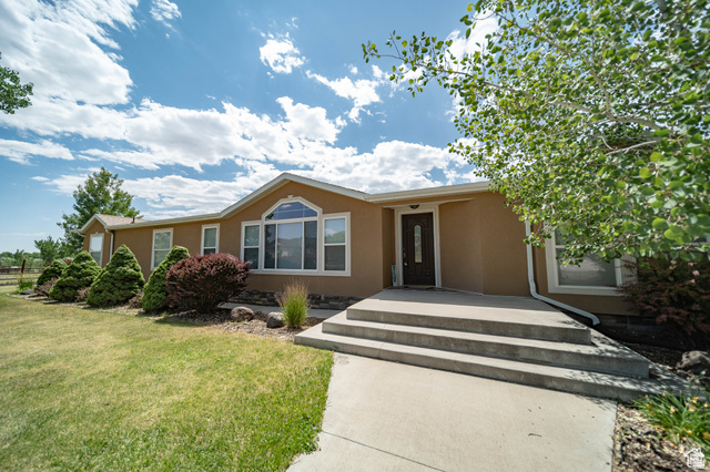1407 North 1250th Street West Helper, UT 84526 - Photo 1 of 27 Ranch-style house with stucco siding and a front yard