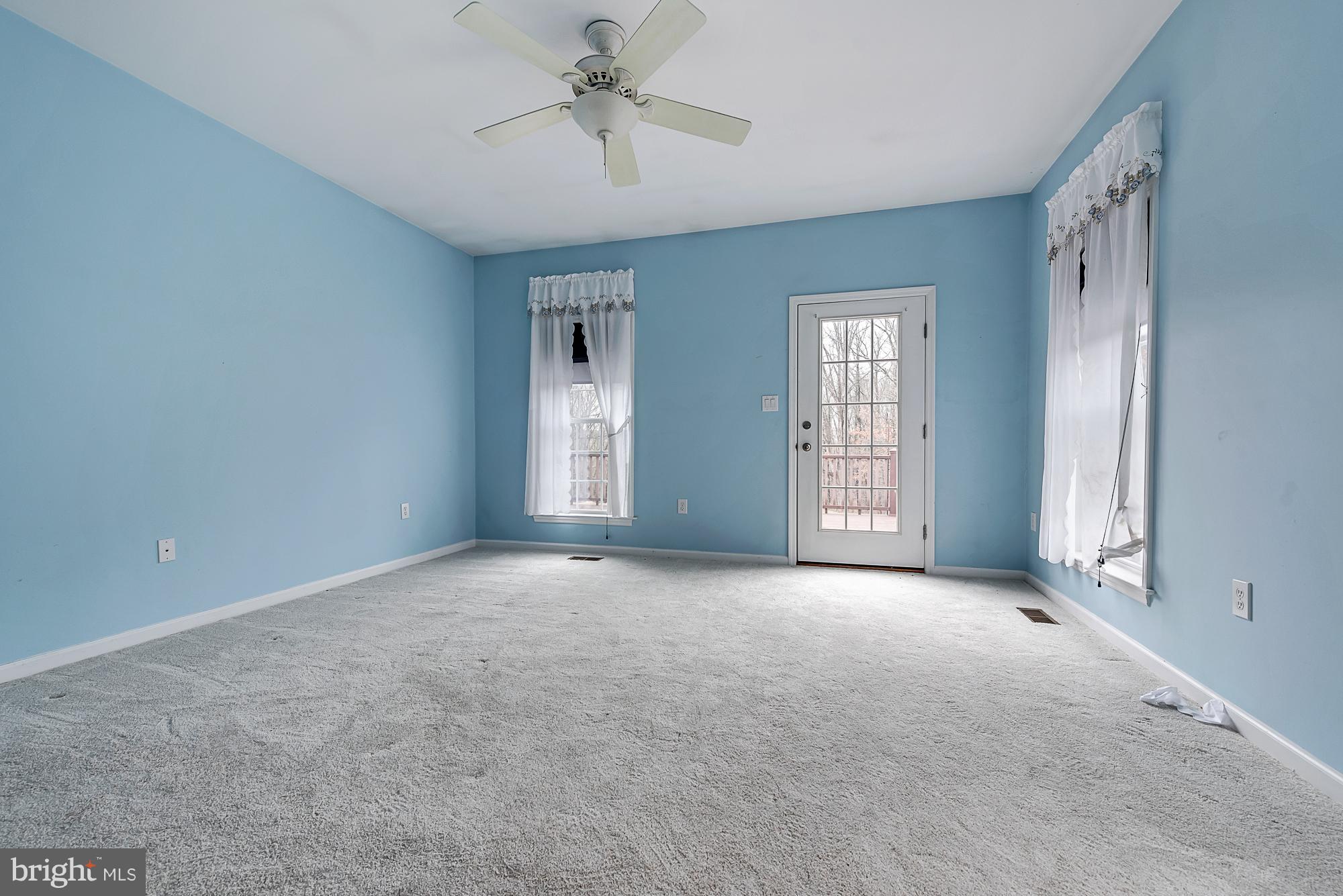 11698 Coppermine Road Union Bridge, MD 21791 - Photo 19 of 24 a view of a big room with windows and chandelier fan