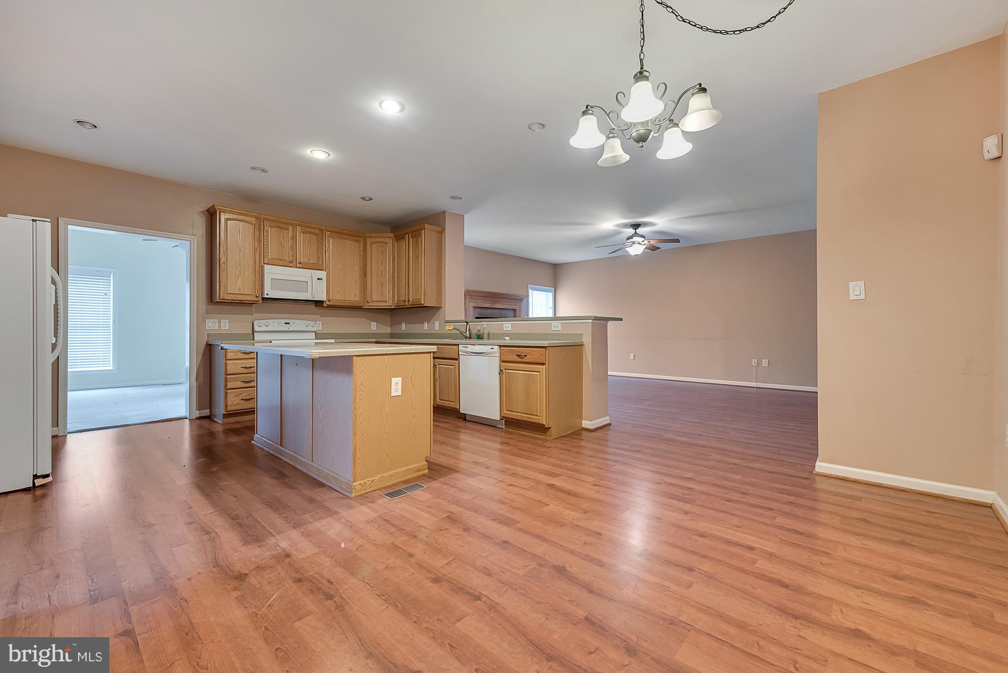 11698 Coppermine Road Union Bridge, MD 21791 - Photo 5 of 24 a view of a kitchen with a sink wooden floor and a refrigerator