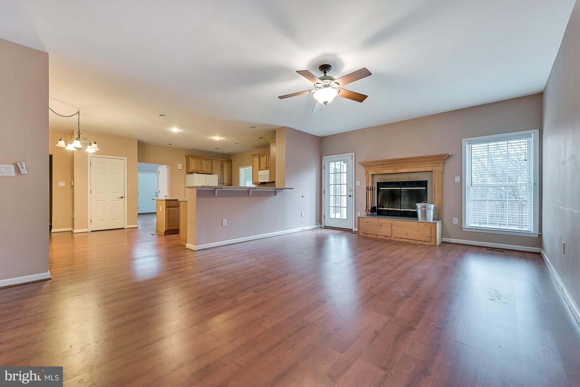 11698 Coppermine Road Union Bridge, MD 21791 - Photo 6 of 24 a view of empty room with wooden floor and fireplace