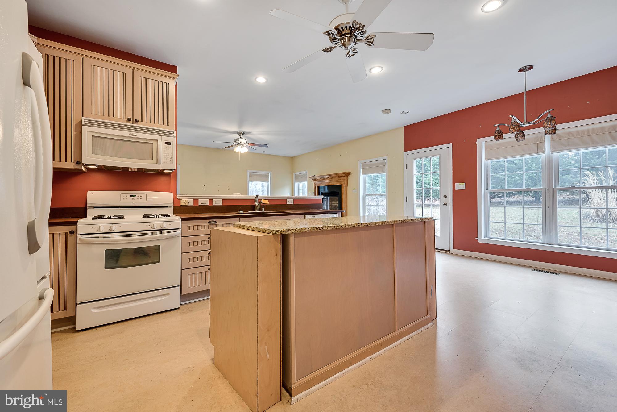 11698 Coppermine Road Union Bridge, MD 21791 - Photo 8 of 24 a kitchen with stainless steel appliances granite countertop a stove a sink and a refrigerator