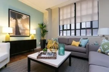 a living room with furniture lamp and window