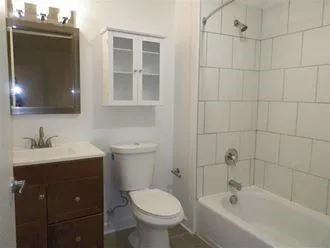a bathroom with a sink toilet and shower