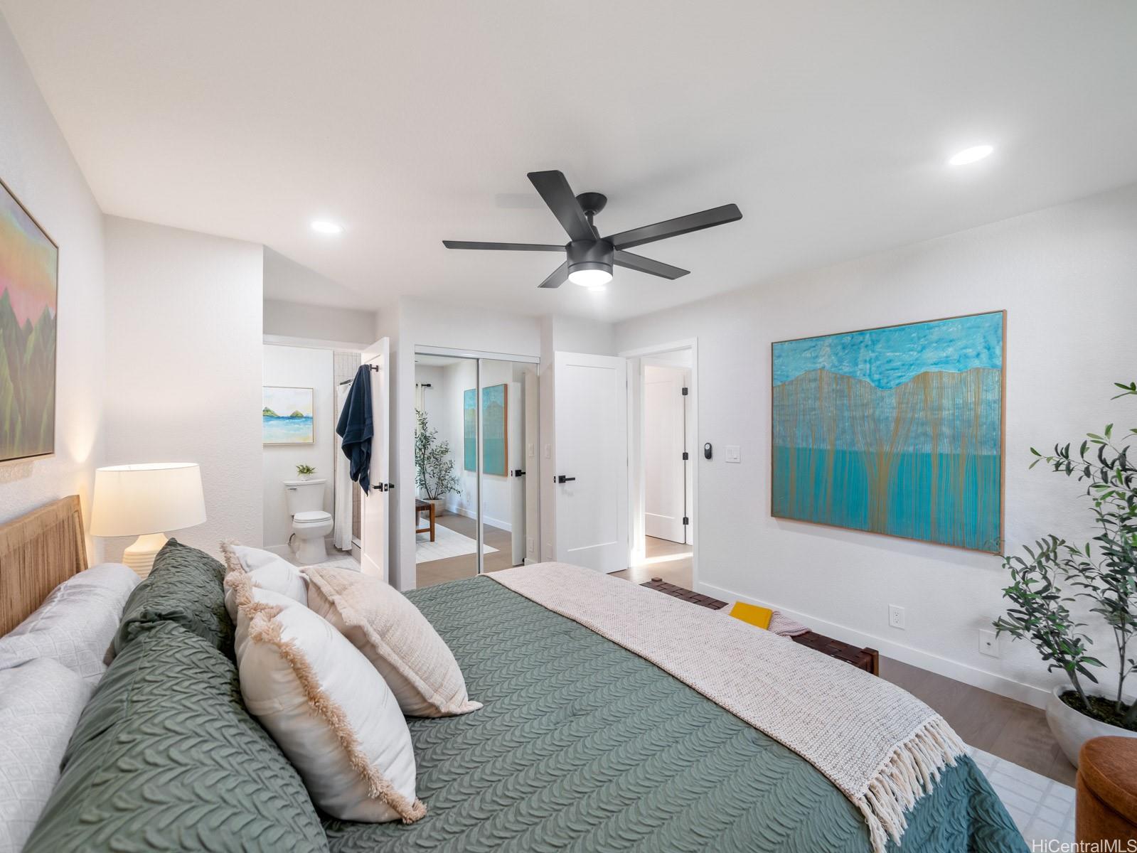 95-664 Wikao Street, Unit L205 Mililani, HI 96789 - Photo 12 of 25 a bedroom with a bed and a chandelier