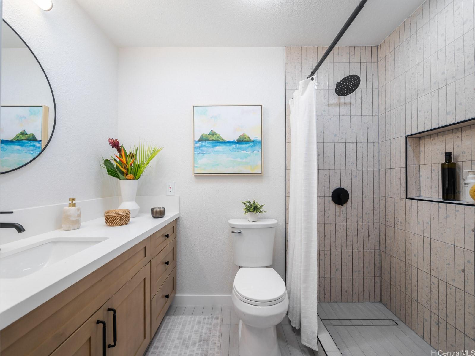 95-664 Wikao Street, Unit L205 Mililani, HI 96789 - Photo 13 of 25 a bathroom with a sink a toilet and shower