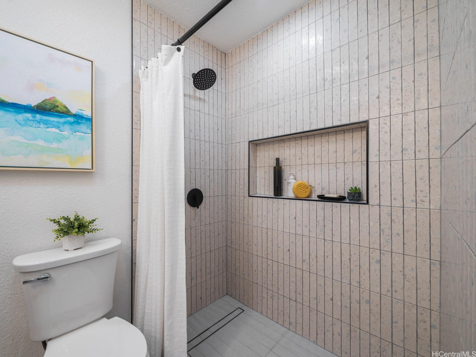 95-664 Wikao Street, Unit L205 Mililani, HI 96789 - Photo 15 of 25 a bathroom with a toilet and shower