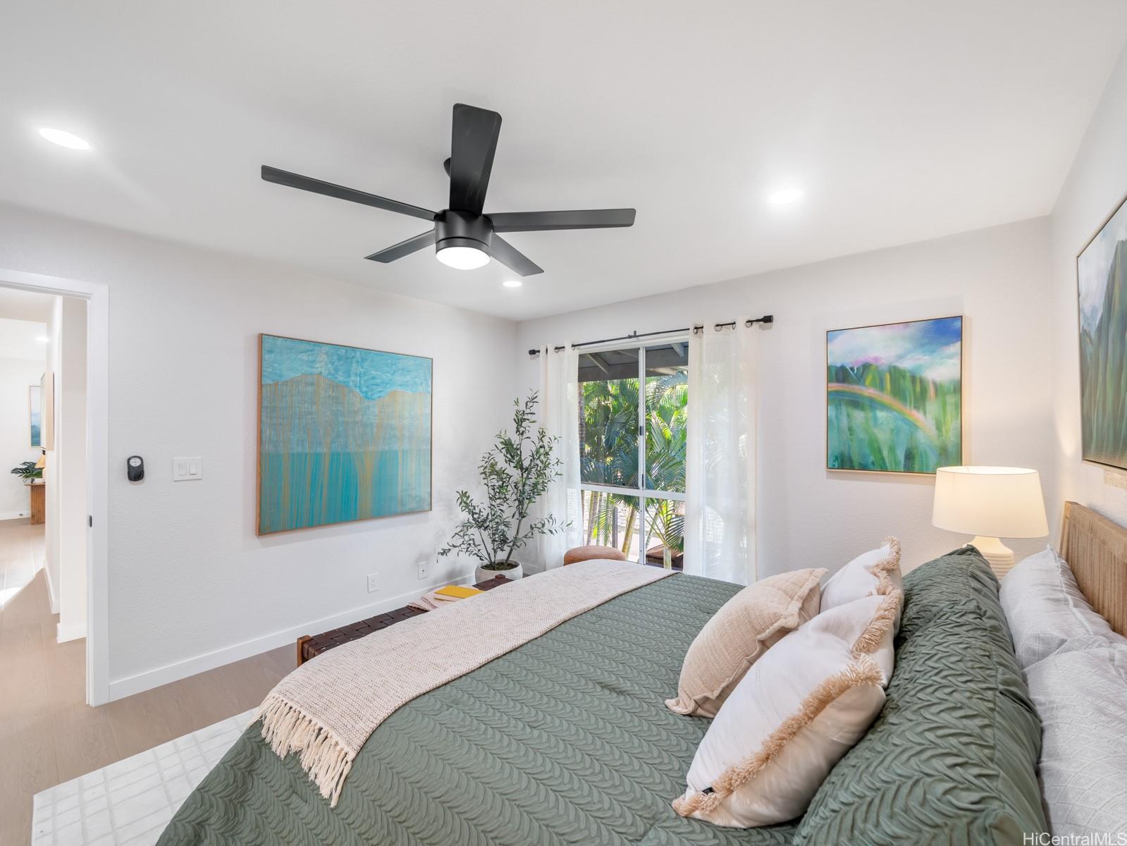 95-664 Wikao Street, Unit L205 Mililani, HI 96789 - Photo 17 of 25 a bedroom with a large bed and a large window