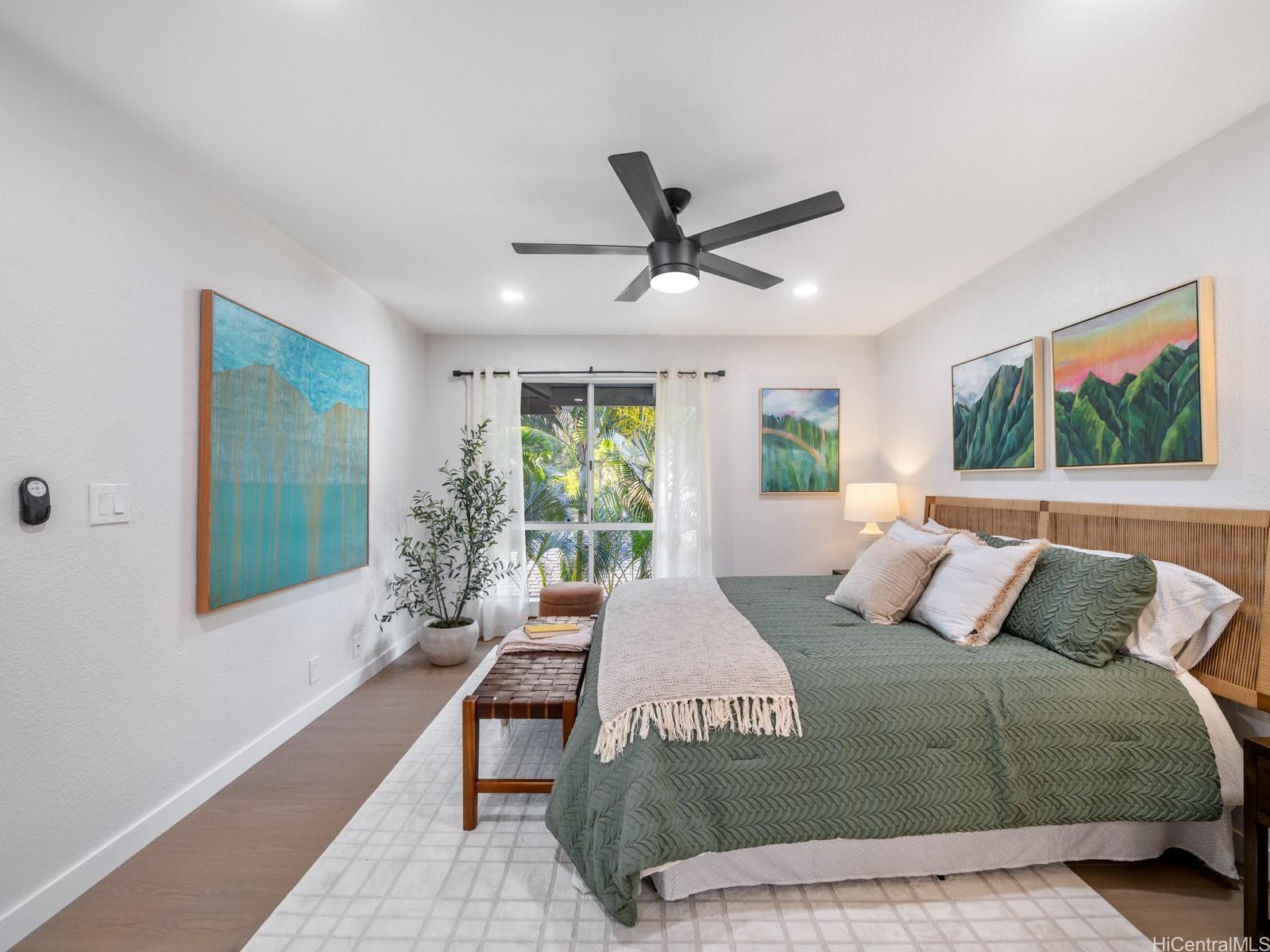 95-664 Wikao Street, Unit L205 Mililani, HI 96789 - Photo 18 of 25 a bedroom with a large bed and a window