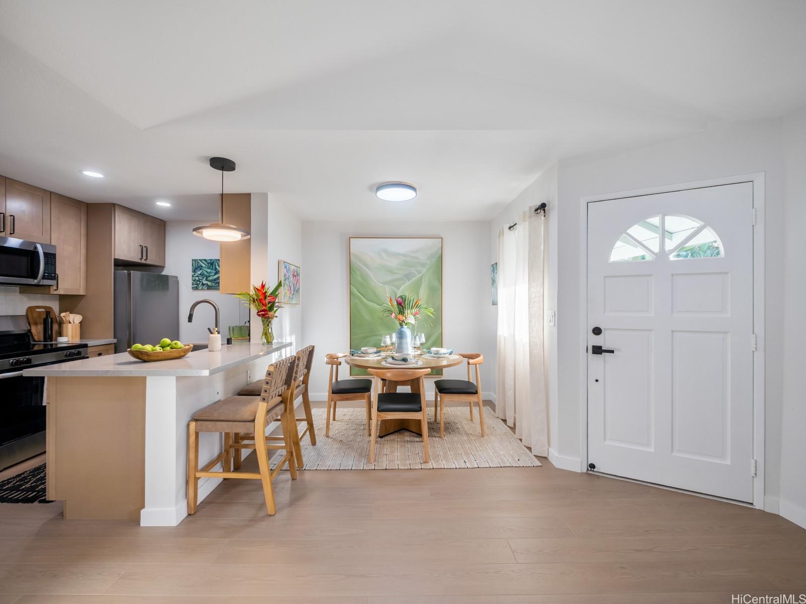 95-664 Wikao Street, Unit L205 Mililani, HI 96789 - Photo 20 of 25 a view of a dining room with furniture window and outside view
