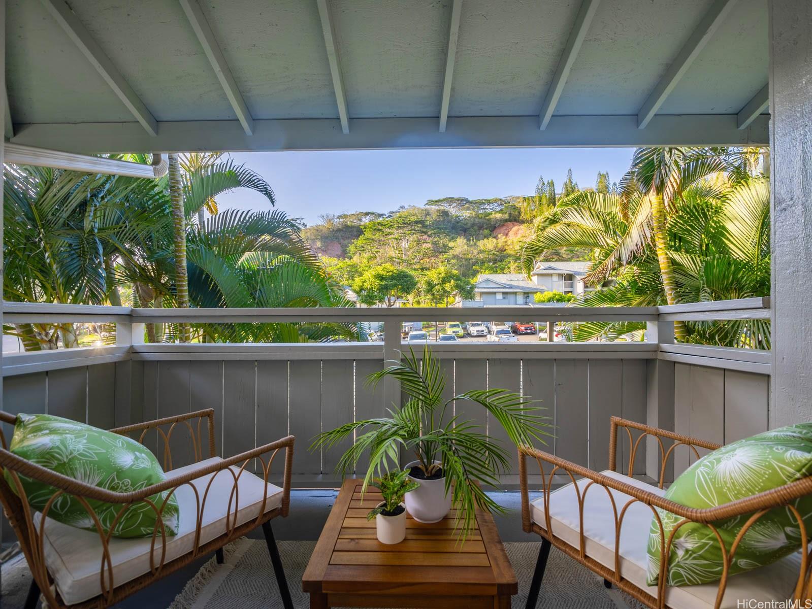 95-664 Wikao Street, Unit L205 Mililani, HI 96789 - Photo 22 of 25 a view of a chairs and table in patio next to a yard